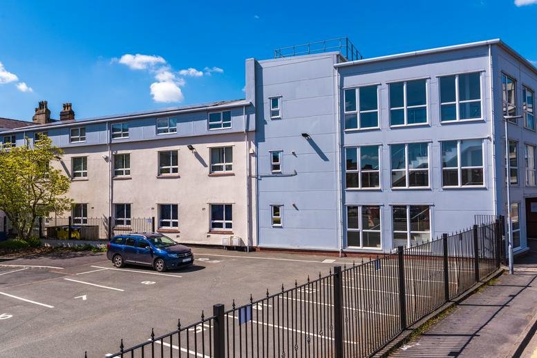 Exterior view of the modern grey and white facade of Ribban Court, 20 Dallam Lane.