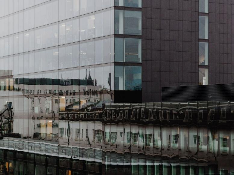 Modern glass and steel exterior of 20 Eastbourne Terrace in London.