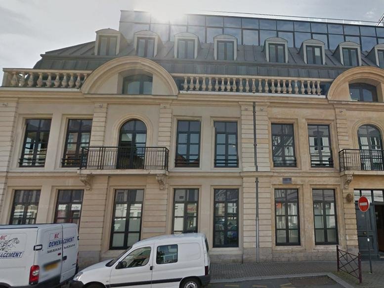 Classic stone facade with large windows at 21 Avenue Le Corbusier.