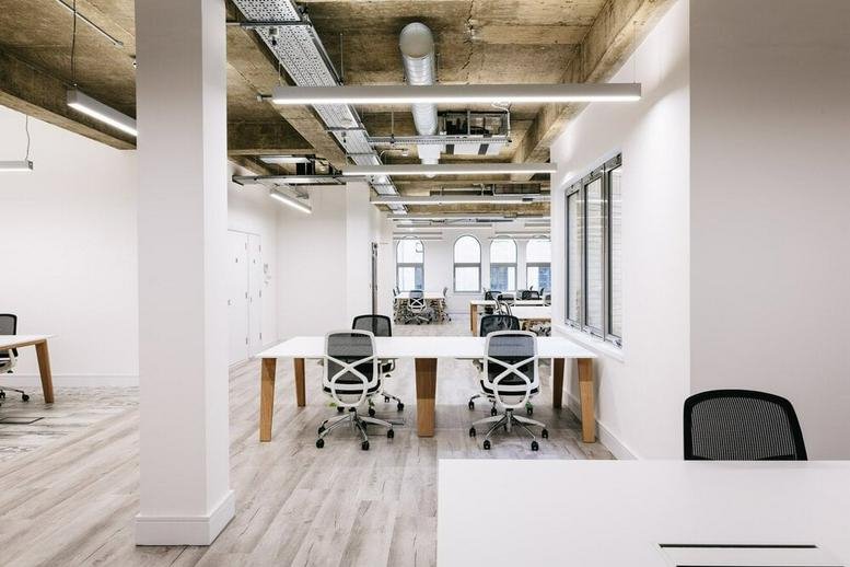 Spacious open-plan workspace at 21 Worship Street, Shoreditch Fringe with industrial ceilings and white desks.