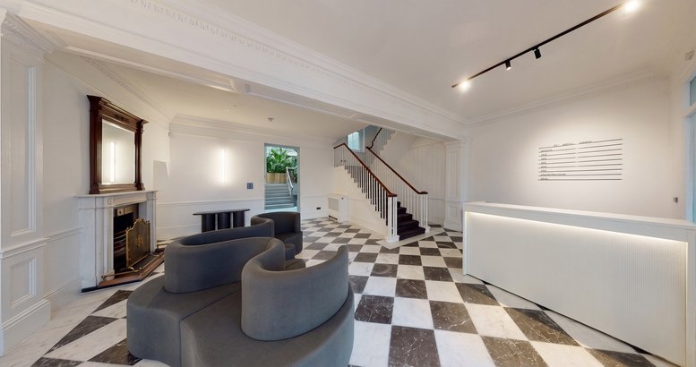 Spacious reception area with checkered marble floors and a white service desk.