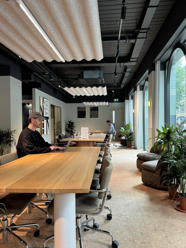 Spacious coworking area at Channel, 22 Northdown Street with long wooden desks and corrugated ceiling panels.