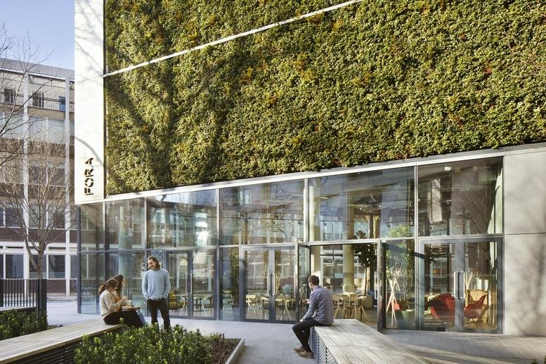 Exterior view of the modern glass facade and vertical garden at 241 Southwark Bridge Road.