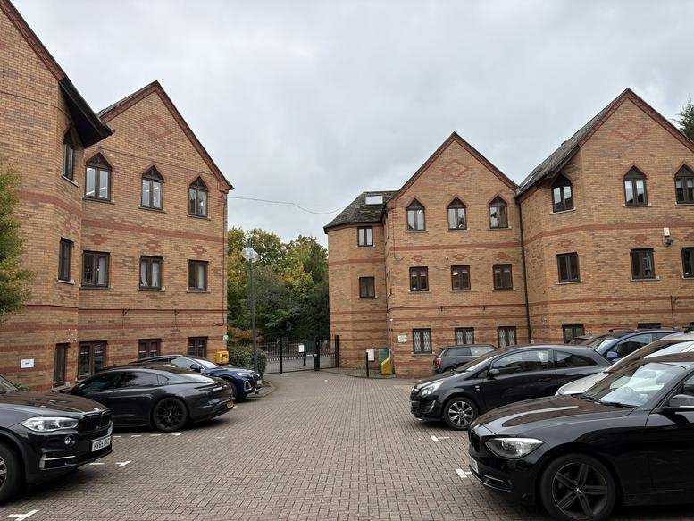 Exterior view of the brick-facade 26-28 Mulgrave Road office complex with parking lot.