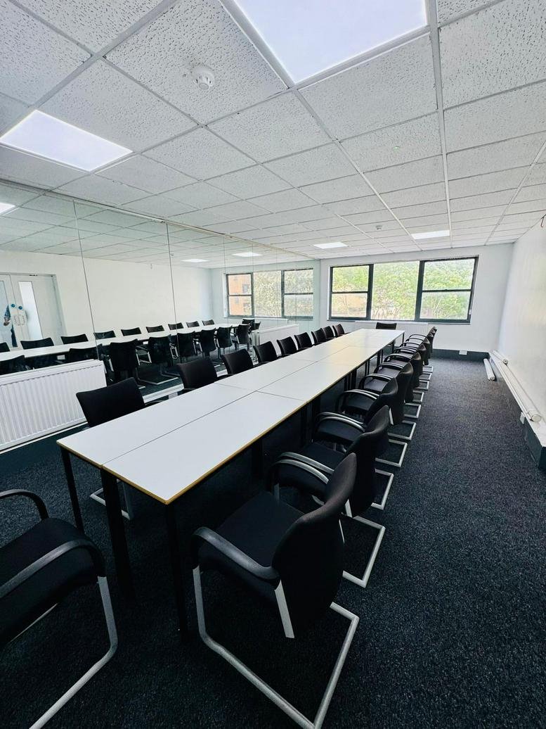 Spacious boardroom with long table and black cantilever chairs at 28-34 Chapel Street.