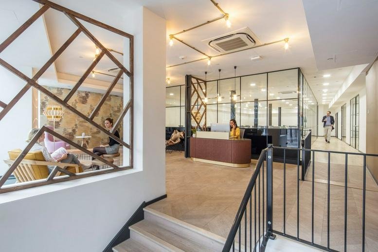 Reception area at 29 Clerkenwell Road with a wooden desk and glass partitions.