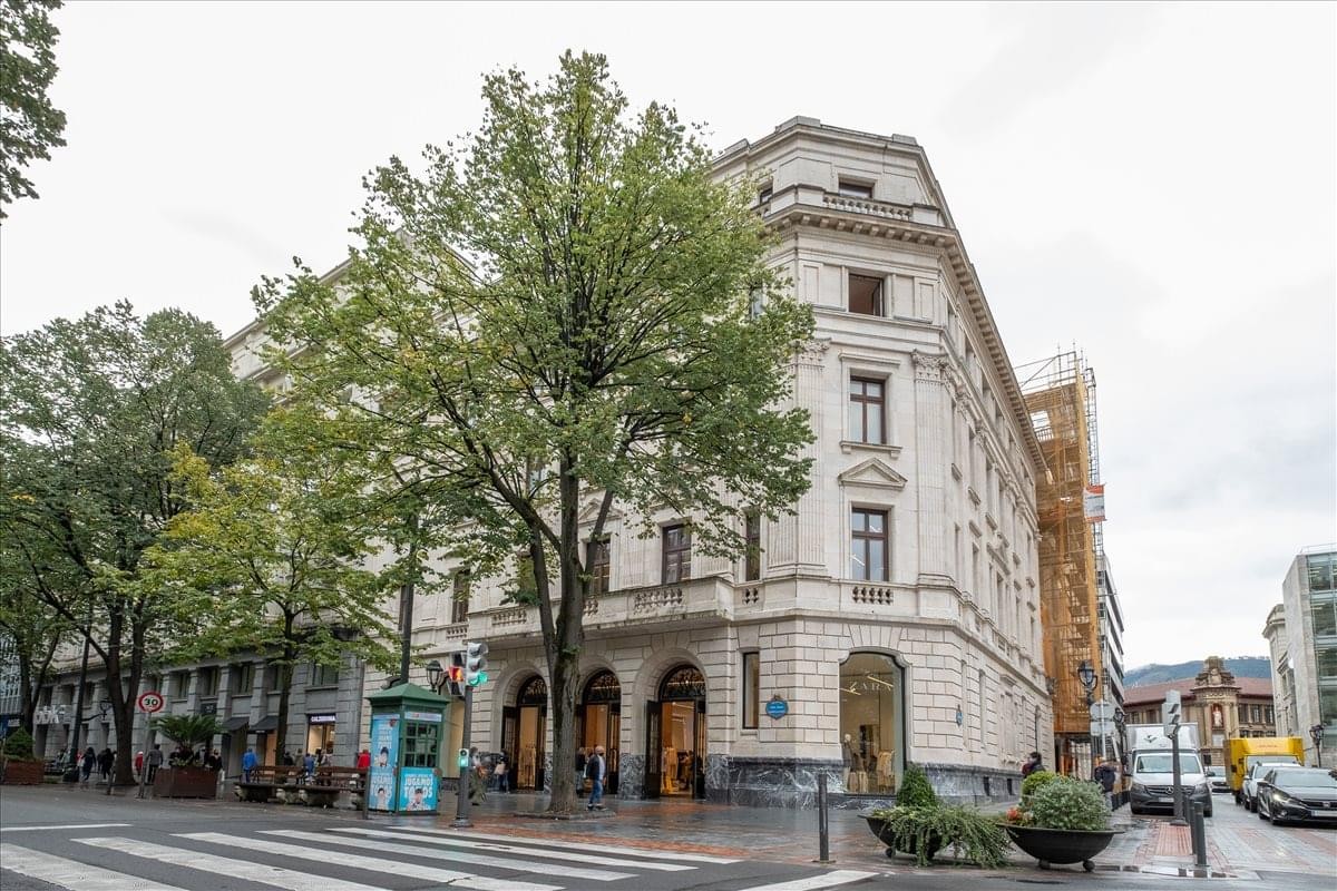 Exterior view of the historic stone building facade at Gran Via 19-21, Central Bilbao.
