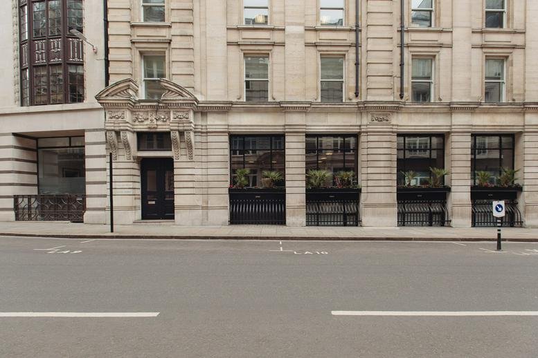 Grand stone facade and entrance of 3 Lloyd’s Avenue in London.