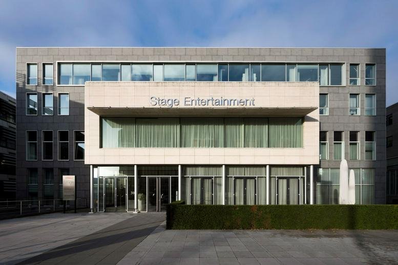 Exterior view of the modern stone and glass building at De Boelelaan 30, Zuidas.