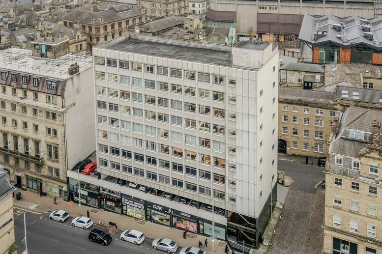 Aerial exterior view of the multi-story West Riding House building and surrounding city streets.
