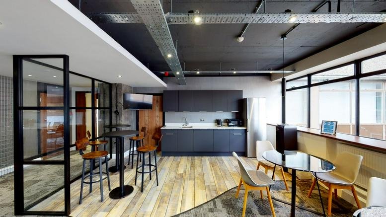 Spacious communal breakout area with a modern kitchen and stylish seating at 33-35 Cathedral Road.