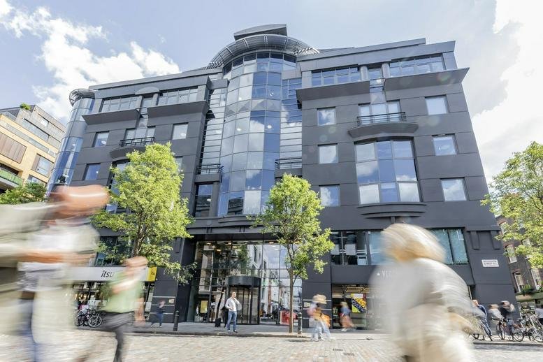 Modern charcoal facade and glass architecture of 33 Broadwick Street, Soho.