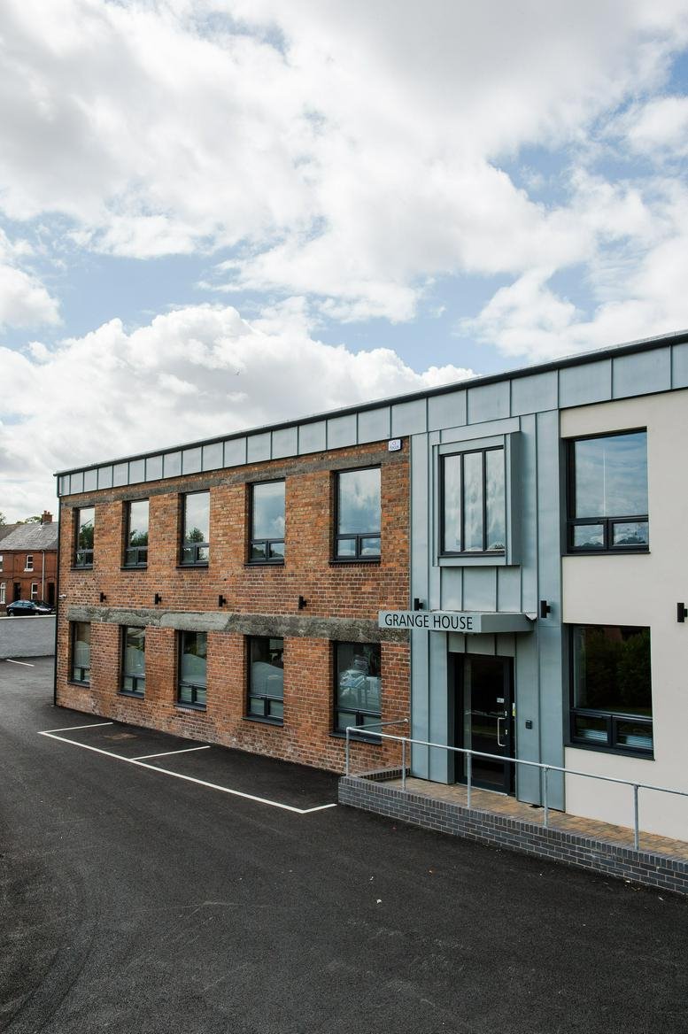 Exterior view of the brick and metal facade of Grange House at 37a Upper Dunmurry Lane.