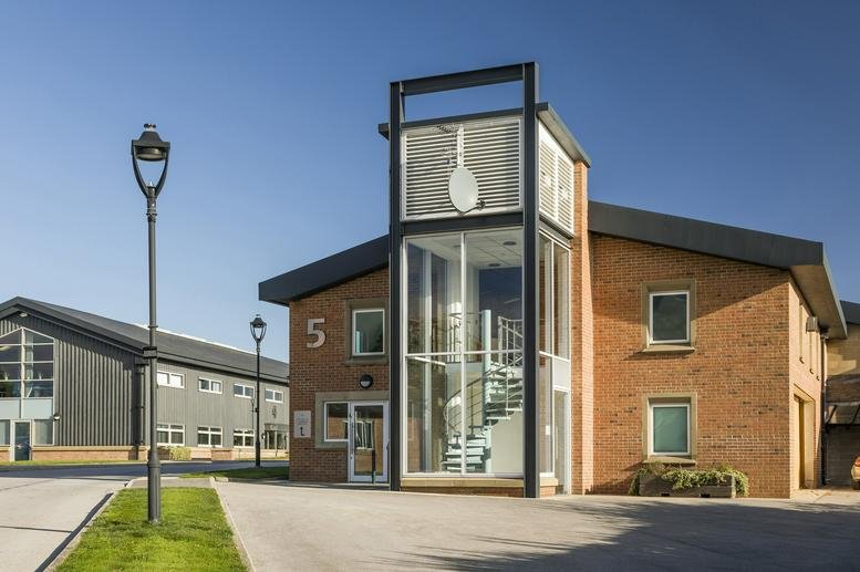 Exterior view of the brick facade and glass entrance at 4 and 5, Carrwood Park.
