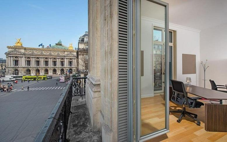 Exterior view of the historic Palais Garnier from a balcony at 4 Place de l'Opera, Paris.