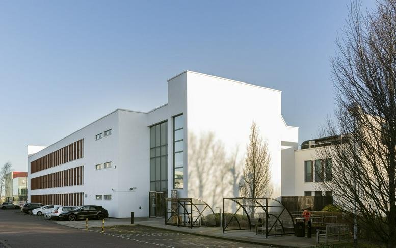 Exterior view of the white modern facade at 4100 Park Approach, Thorpe Park.
