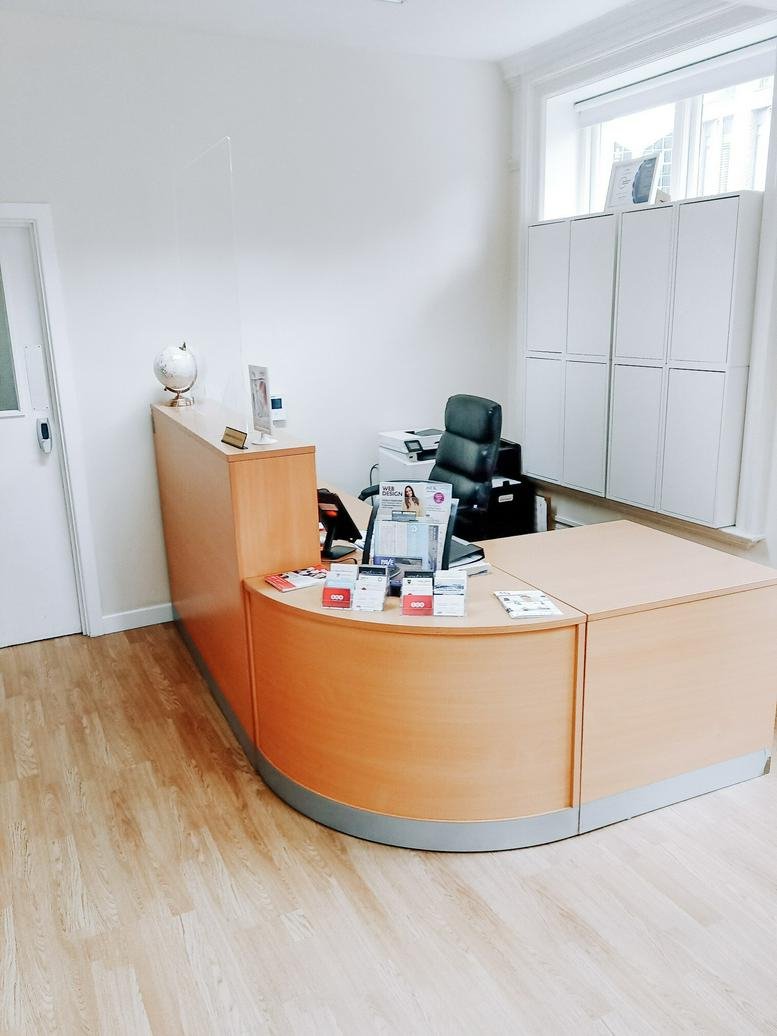 Bright reception area at 1st Floor, 415 High Street, Stratford with wooden desk and floor.
