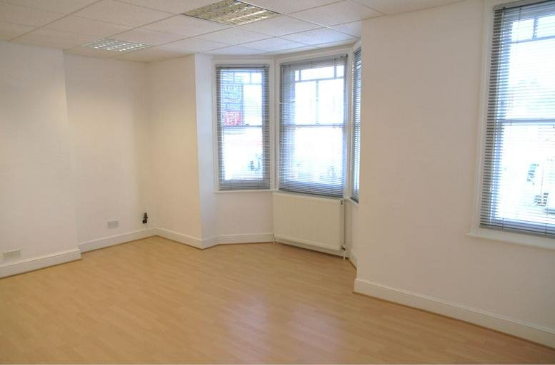 Spacious interior office suite at 42 Watling Street featuring wood floors and bay windows.