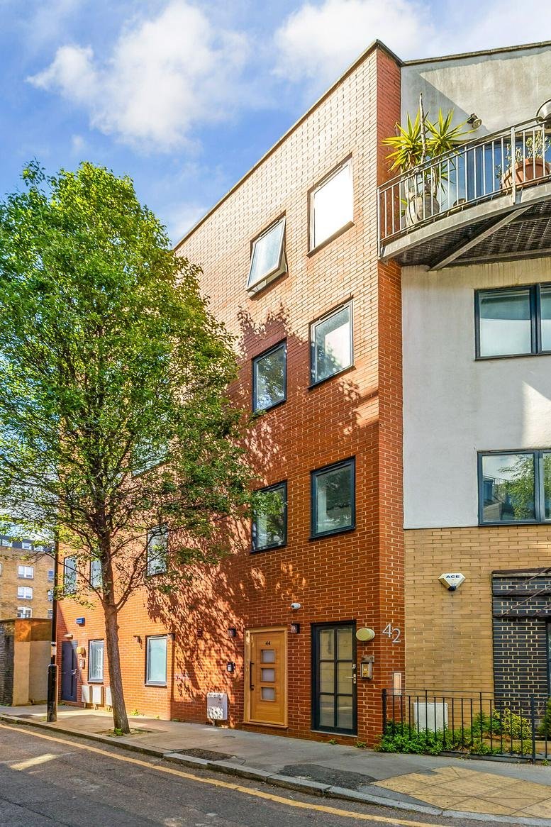 Modern red brick building exterior at 44 Copperfield Street with large windows.