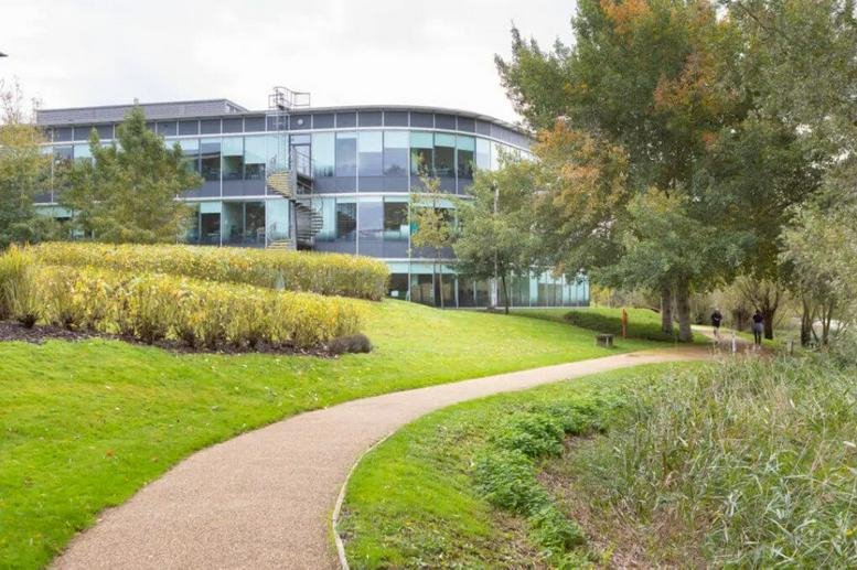 Exterior view of the curved glass building at 450 Brook Drive, Green Park Business Park.