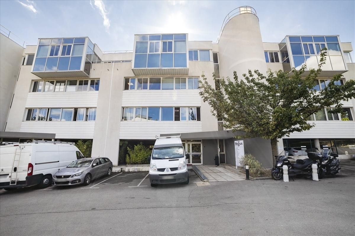 Exterior facade of 450 Rue Baden Powell with distinctive glass cube balconies.
