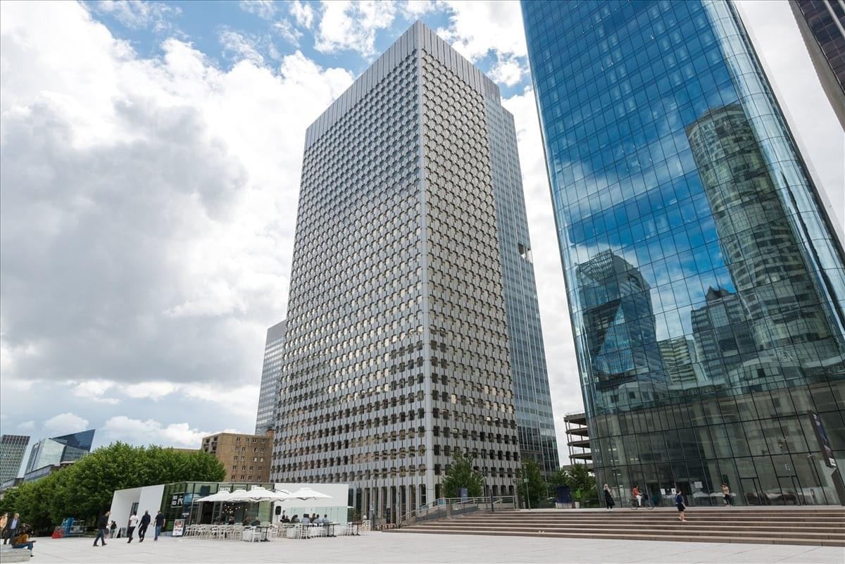 Exterior view of the towering glass and concrete facade of 5 Place de la Pyramide, Tour Ariane La Defense 9.