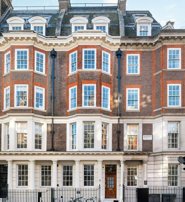 The red brick and white stone facade of 56 Grosvenor Street, Mayfair, London, United Kingdom.