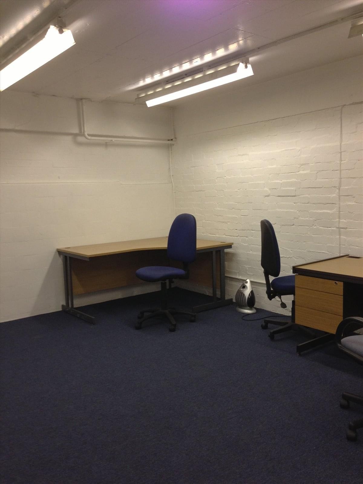 Spacious two-person office with corner desks and blue ergonomic chairs at 592 London Road, Isleworth.