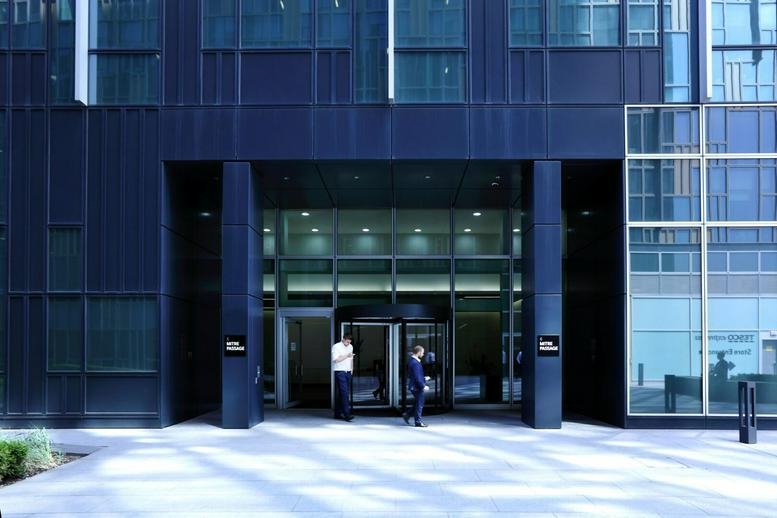 Exterior view of the dark glass facade and entrance of 6 Mitre Passage.