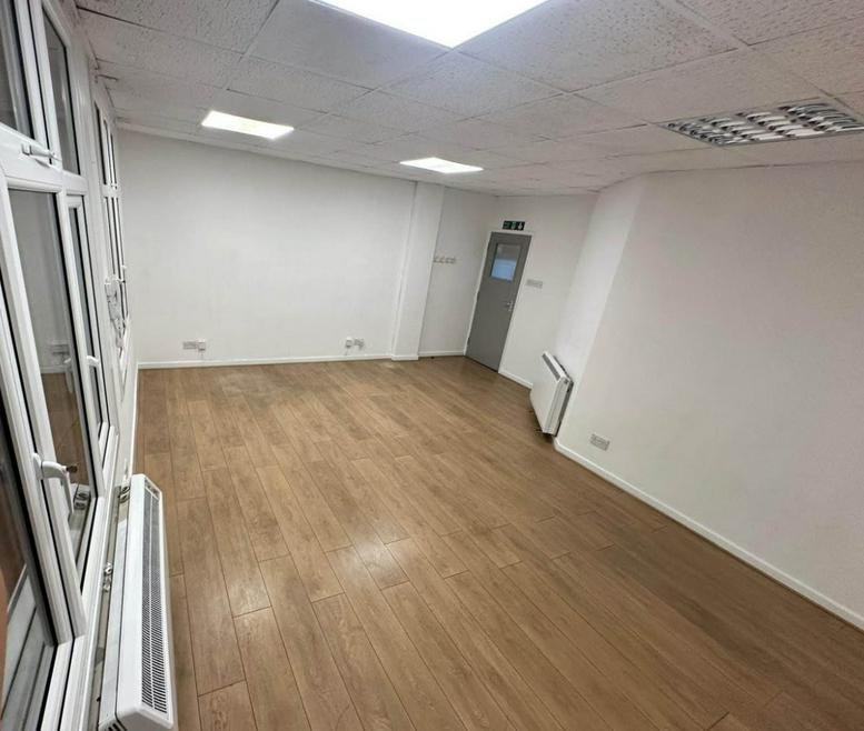 Bright, empty office space at 61A Southbury Road with wooden floors and white walls.