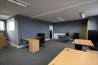 Spacious open-plan office suite with multiple wooden desks at 62A, Bridge Road East, Welwyn Garden City.