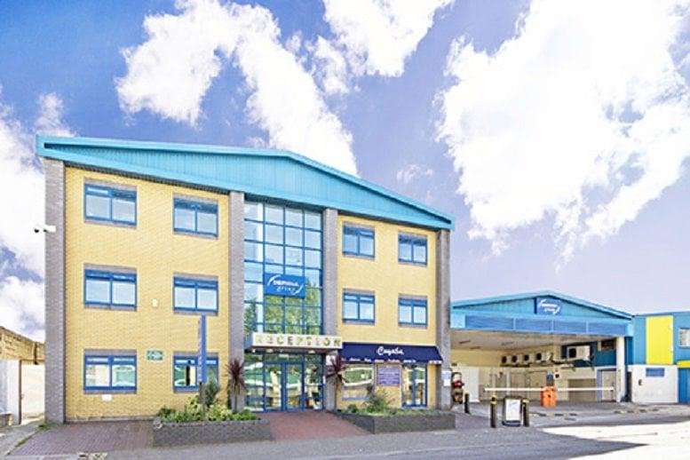 The yellow brick exterior and glass entrance of 7 Coronation Road, Park Royal, Central London, NW10, UK.