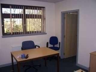 Private office at 7 New Law House, Saltire Centre featuring a wooden desk and two blue chairs.