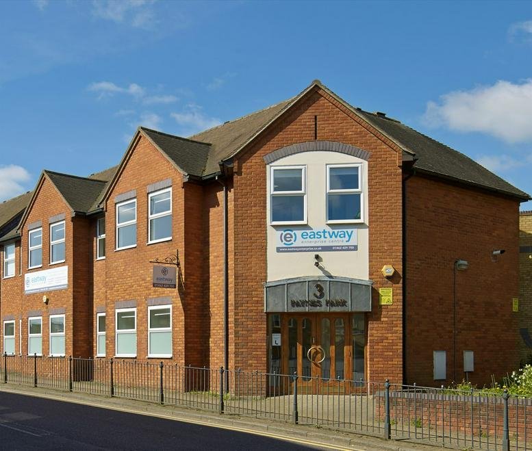 Exterior view of the red brick building at 7 Paynes Park with large front windows.