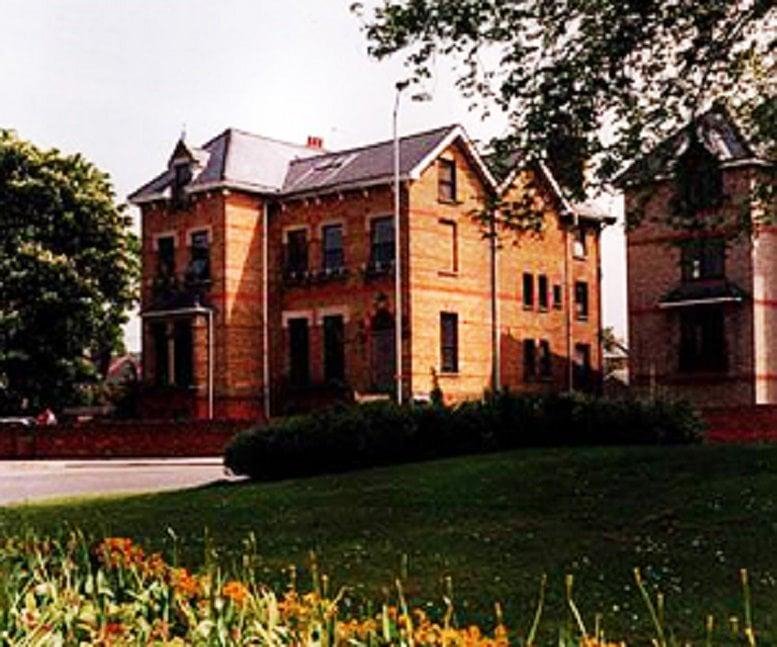 Exterior view of the traditional brick building at 70-72 Alma Road.