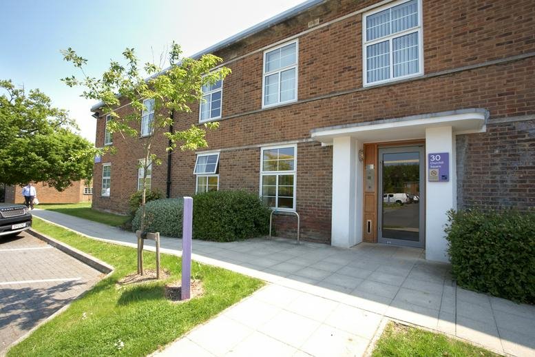 Exterior facade of 70 Churchill Square, Kings Hill, Kent featuring brick architecture and white-framed windows.