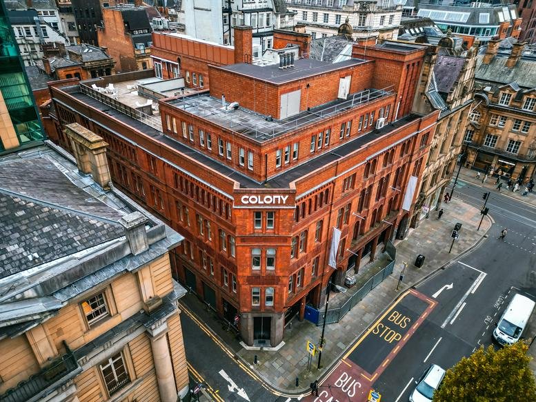 High-angle exterior of the red brick building at 76, King Street, Manchester.