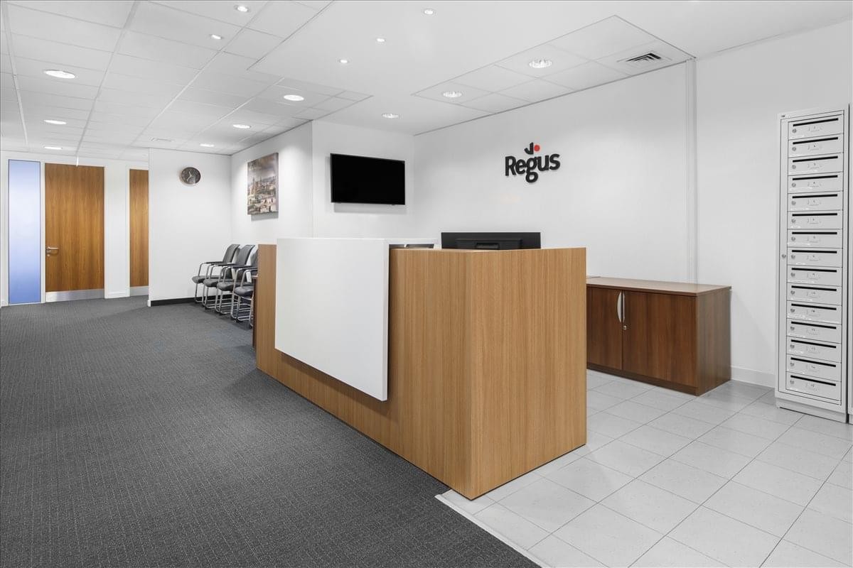 Professional reception area at 79 College Road, Harrow with a wood-fronted desk and branded wall.