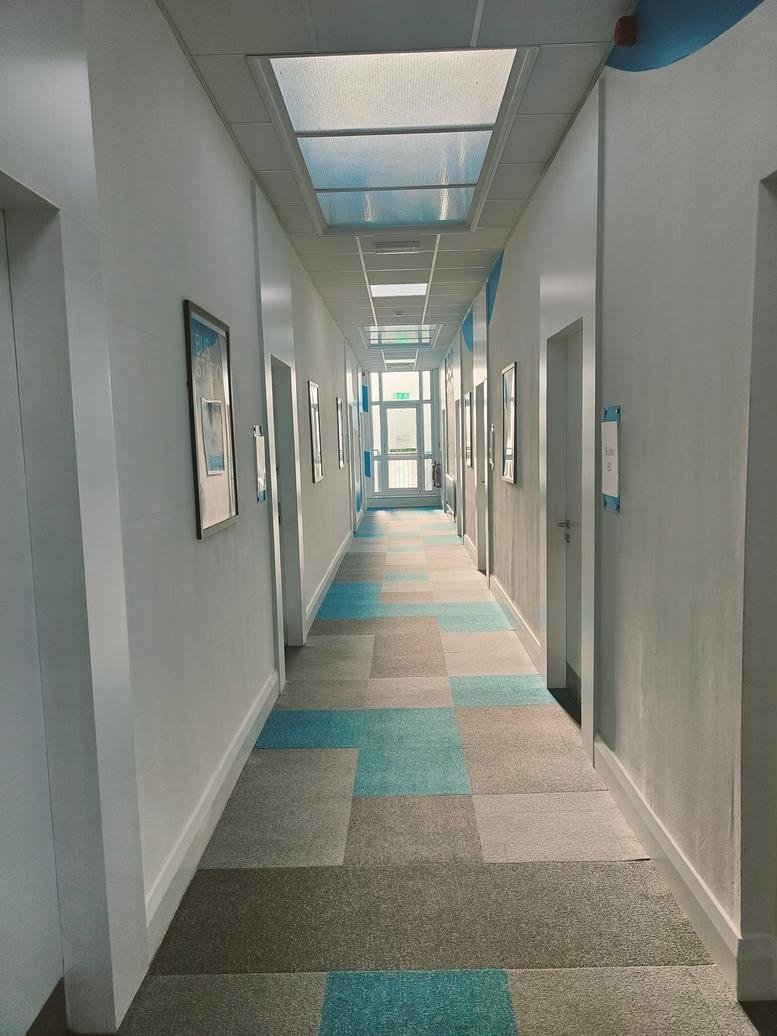 Wide exterior shot of the two-story brick office building and street-side entrance.