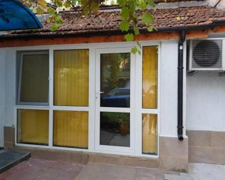 Exterior entrance at 9 Petko Karavelov Street, Ground Floor, Kapana, Plovdiv with glass doors and white frames.
