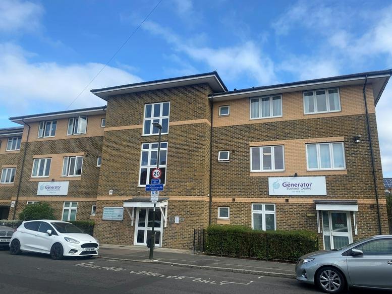Exterior facade of The Generator Business Centre, 95 Miles Road, Mitcham showing a brick building and parking.