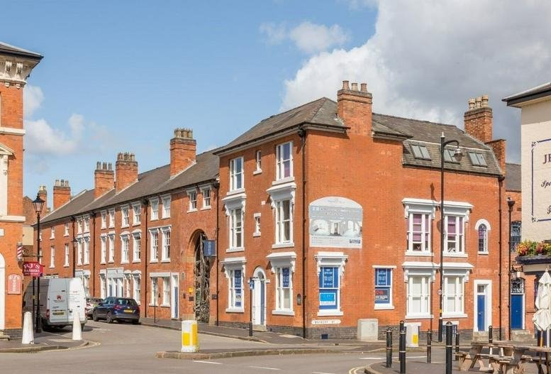 Red brick exterior of the Jewellery Business Centre, 95 Spencer Street, Birmingham with large arched windows.