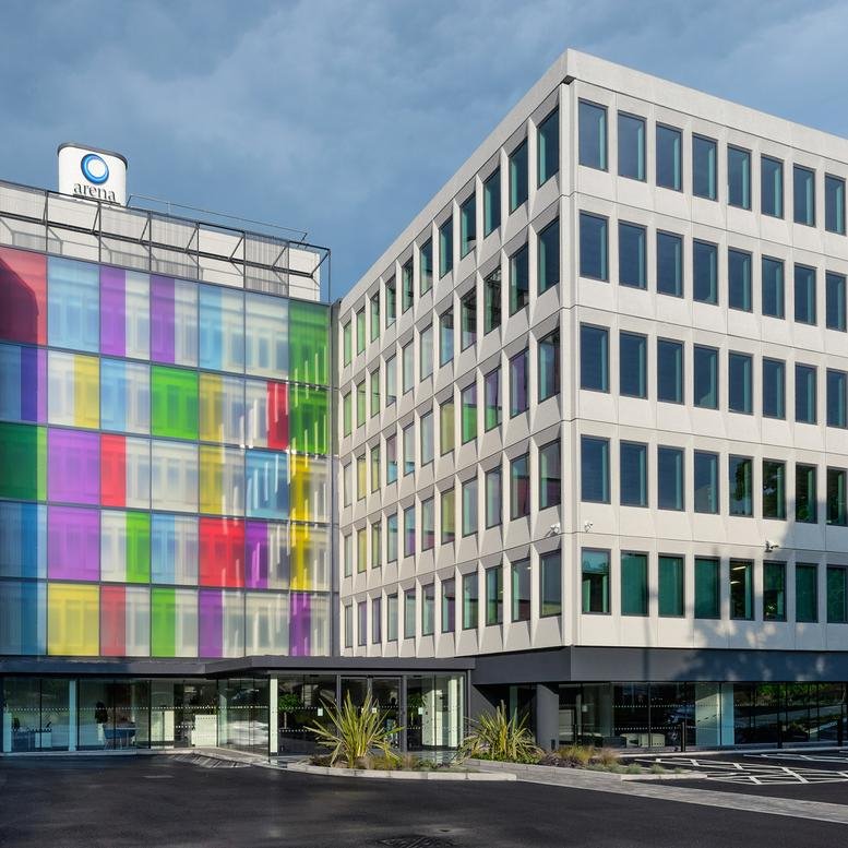 Modern exterior of Abbey House, Farnborough Road, featuring a colorful glass facade and clean white architecture.