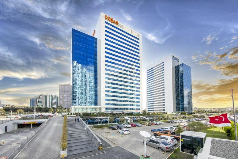 Exterior view of the modern glass and white facade of Akkom Office Park.