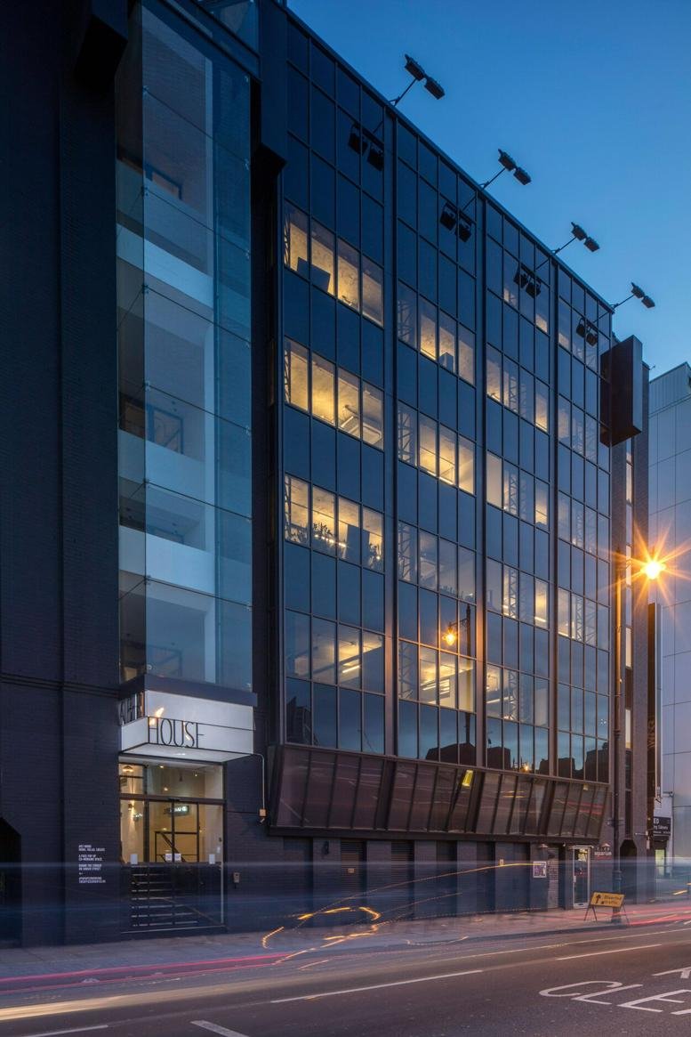 Evening exterior view of the modern glass-fronted Albert House building.