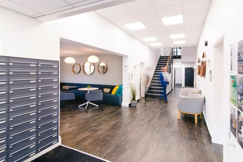Spacious reception area at Alexandra Road, Farnborough with mailboxes and stairs.