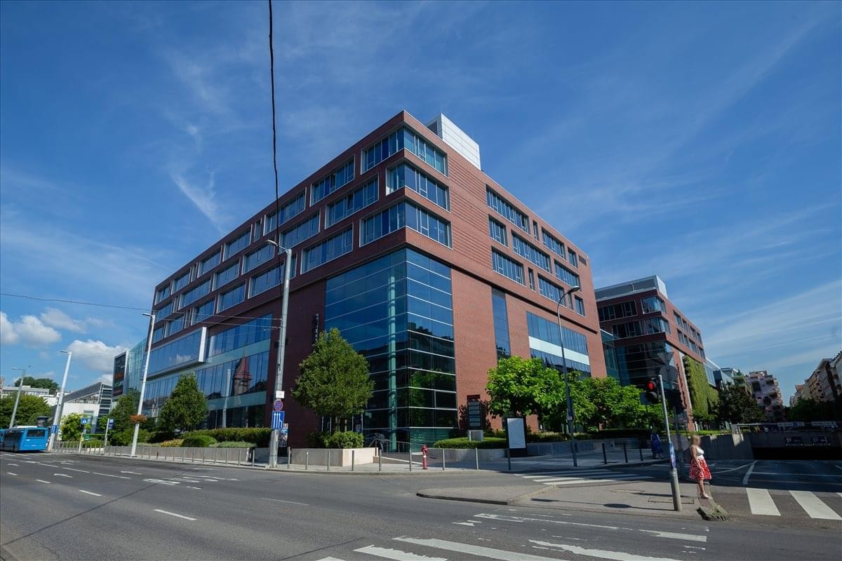 Modern exterior of the red brick and glass-facade Allee Corner building in Budapest.