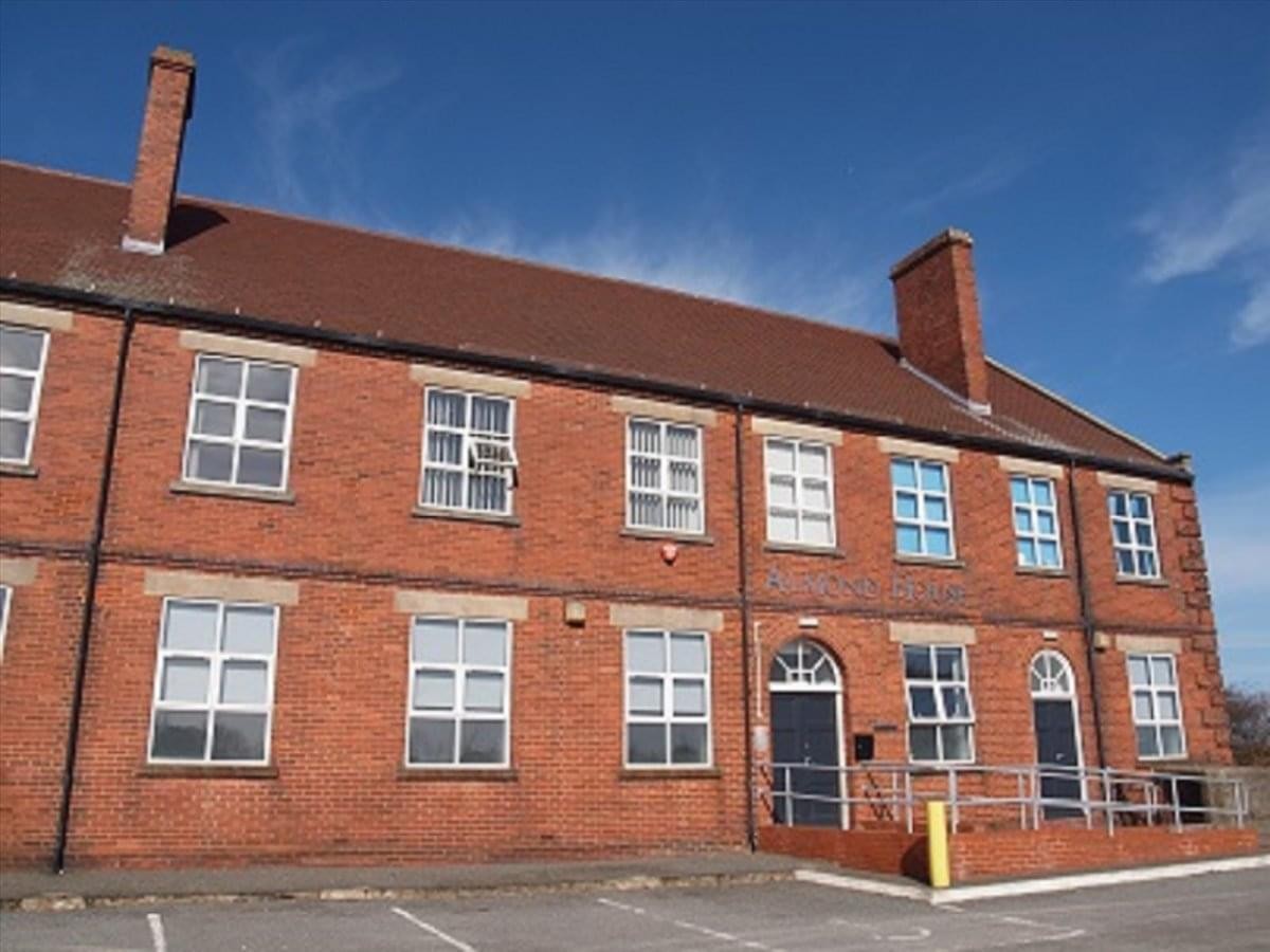 Exterior view of the red brick facade at Almond House, Betteshanger Road.