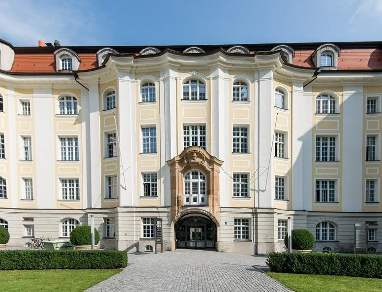 Exterior facade of the historic Alte Hopfenpost building featuring a grand arched entrance.