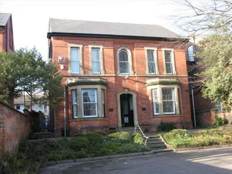 Exterior facade of the red-brick Anderson House with arched entryway and bay windows.